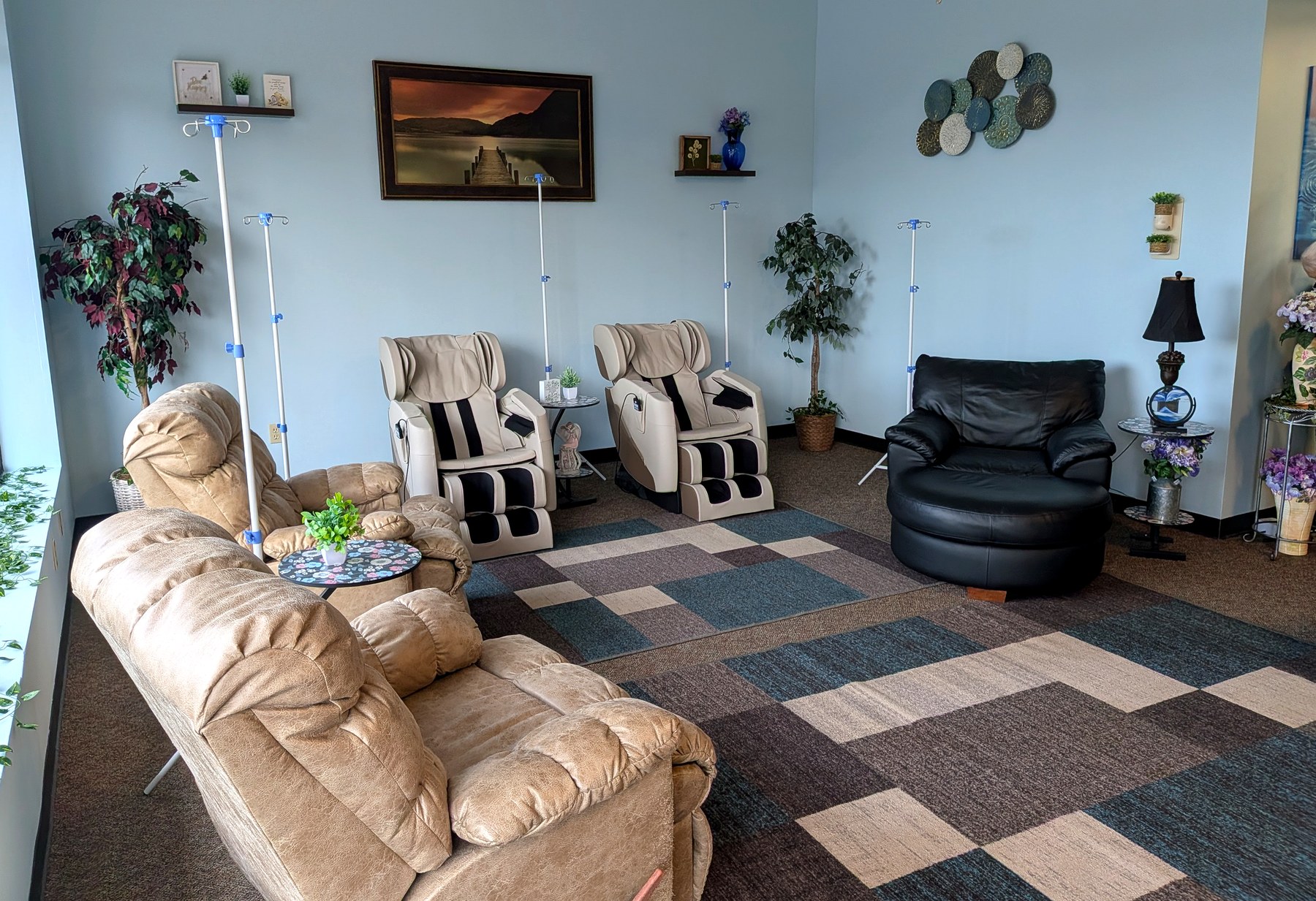 Inside the Hydro Harmony IV hydration lounge in Milford, Ohio — recliners, massage chairs, and a calm, homey space